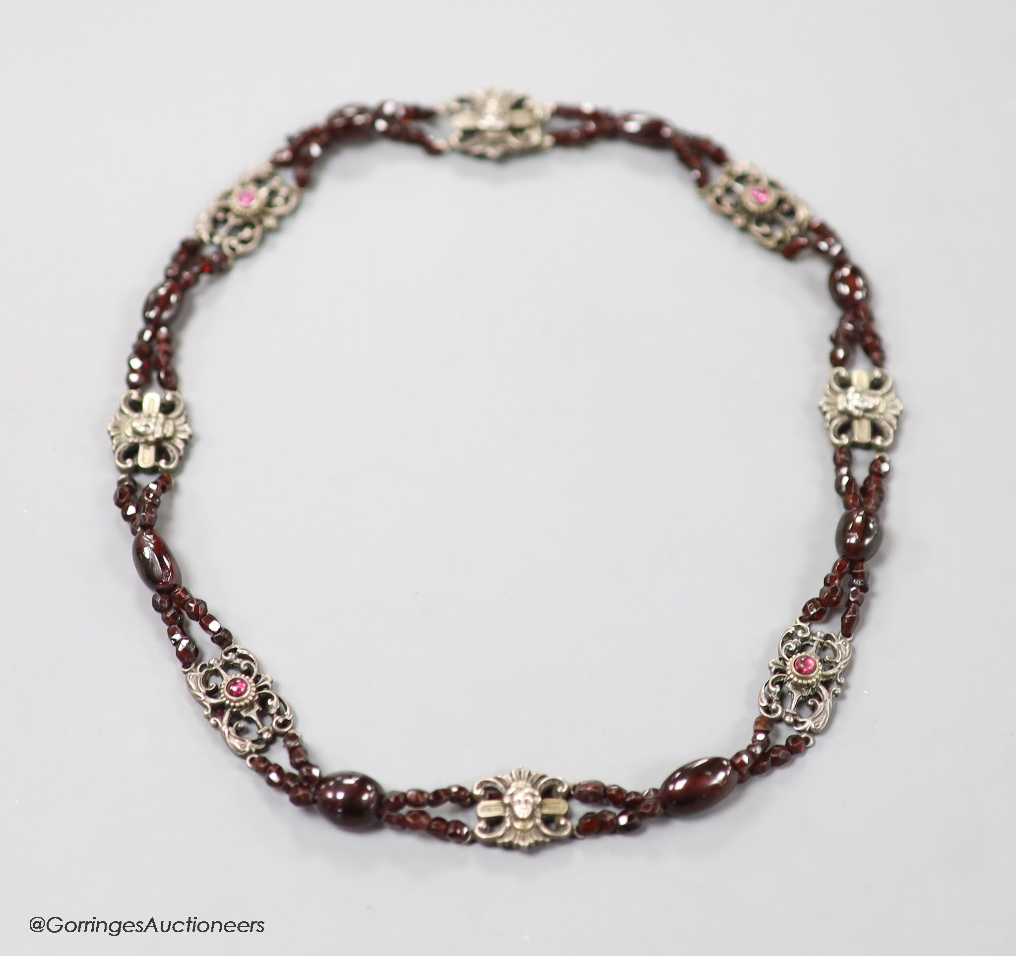 An early 20th century white metal, garnet and red paste? set choker necklace, 40cm.